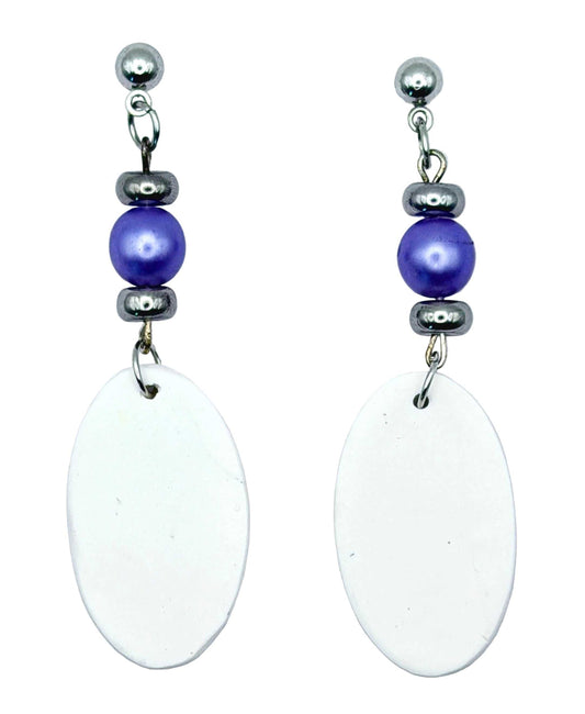 A pair of handmade dangle earrings featuring large, flat white oval discs hanging from silver-toned posts with a purple bead and dark gray spacer beads, set against a light gray background.