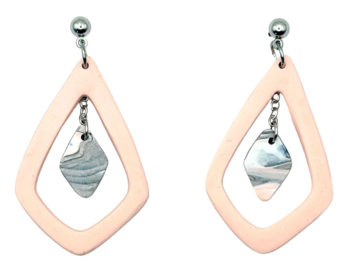 A pair of handmade dangle earrings featuring a peach-pink geometric frame with a silver-toned marbled stone charm, shown on a light textured background.