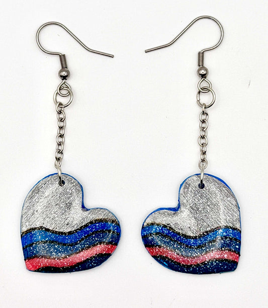 Handmade statement earrings featuring a grey hand painted design attached to silver chains and hooks.