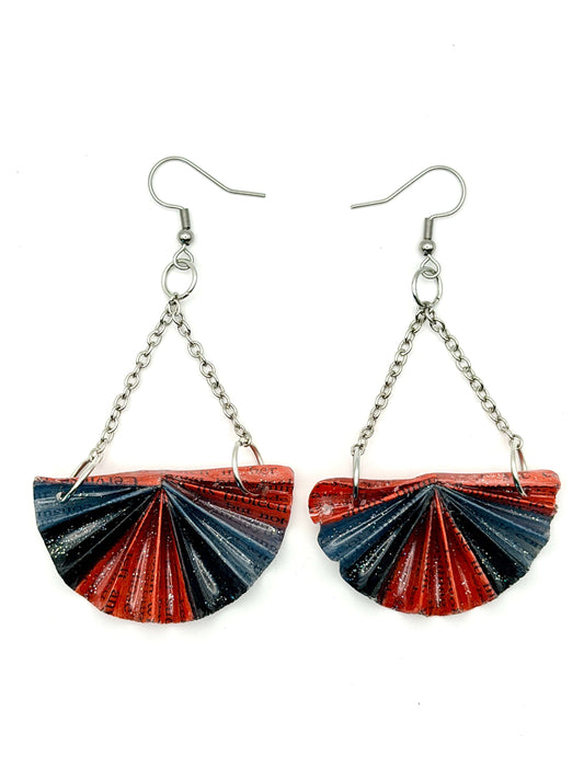 Handmade statement earrings featuring folded recycled book pages in red and black, attached to silver chains and hooks.